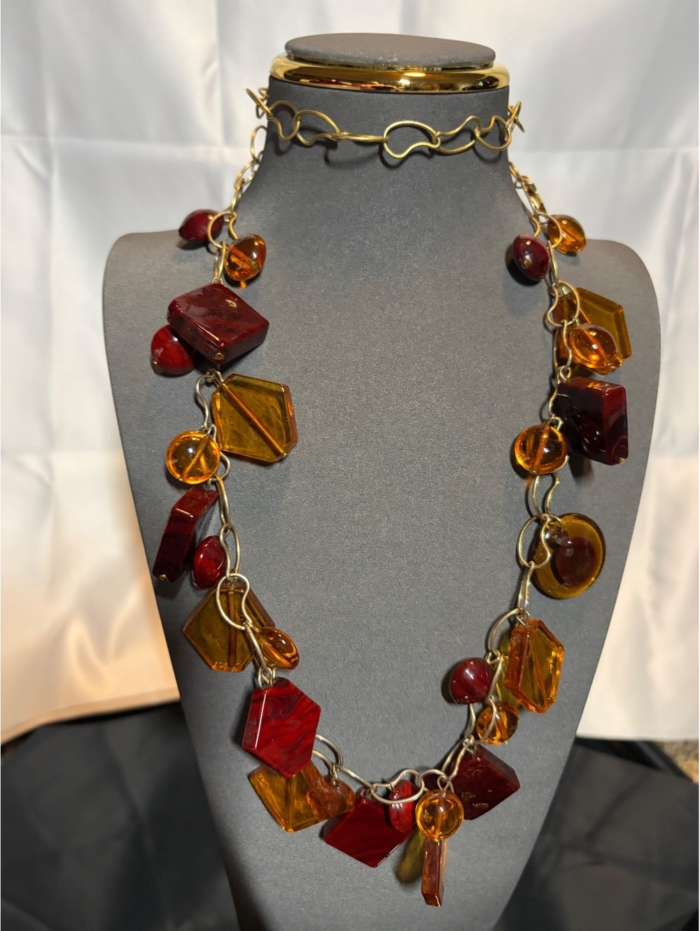 Gold tone chain necklace with amber and red acrylic beads